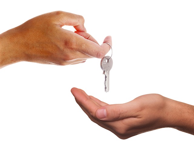 man handing keys to another man