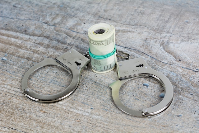 role of money and handcuffs